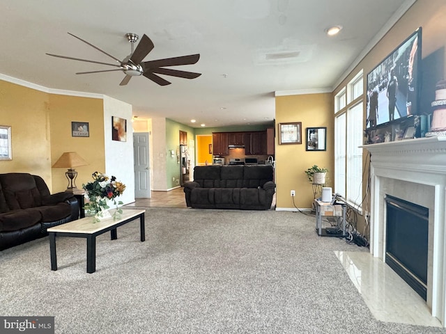 carpeted living room with crown molding, a fireplace, and ceiling fan