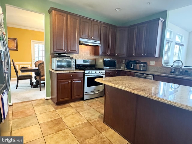 kitchen with sink, appliances with stainless steel finishes, dark brown cabinets, light tile patterned floors, and ornamental molding