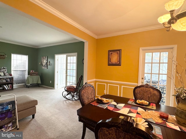 dining room featuring carpet flooring and crown molding