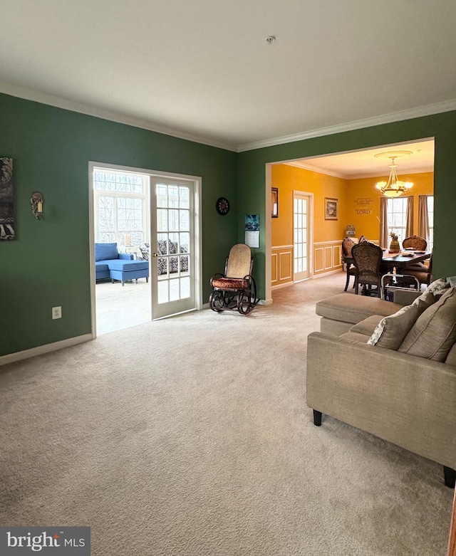 living room with carpet flooring, a healthy amount of sunlight, and ornamental molding