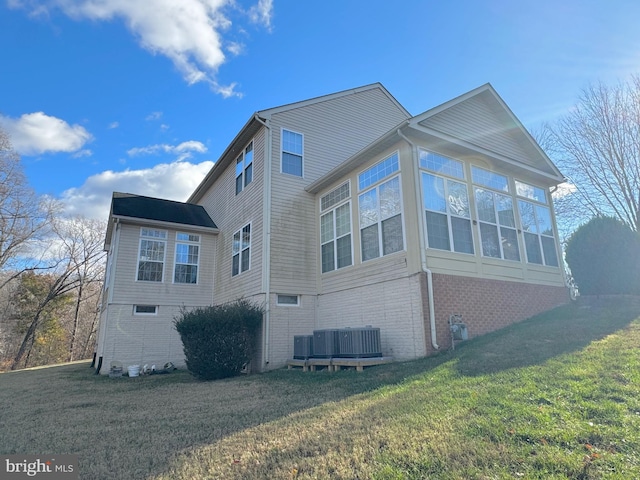 view of property exterior featuring a lawn and a sunroom