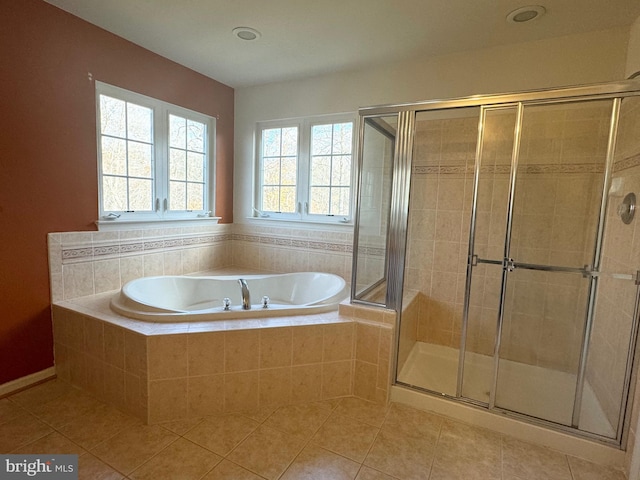 bathroom with tile patterned flooring and separate shower and tub