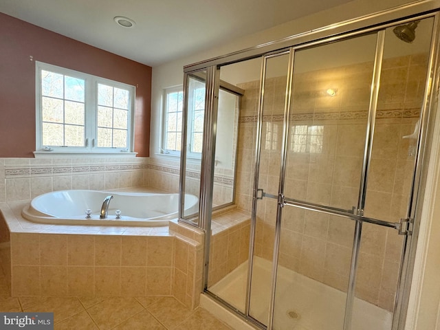 bathroom featuring tile patterned flooring and shower with separate bathtub