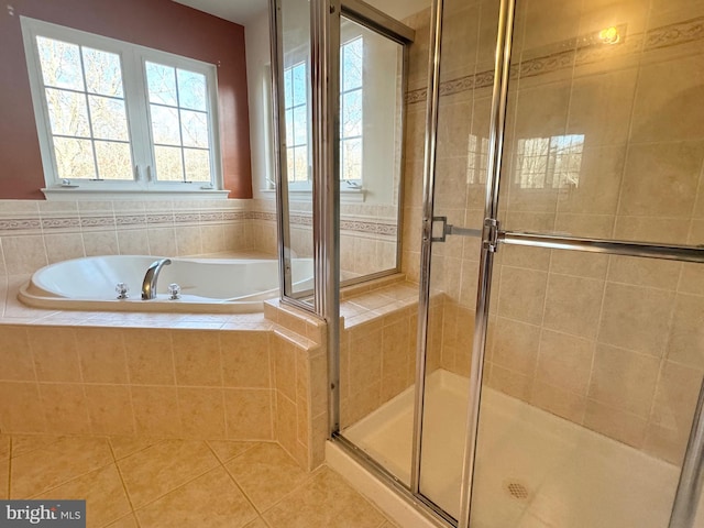 bathroom with separate shower and tub and tile patterned flooring