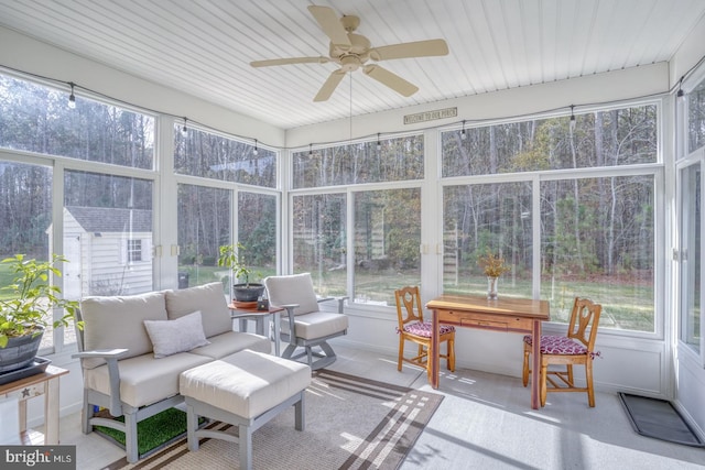 sunroom with a wealth of natural light and ceiling fan