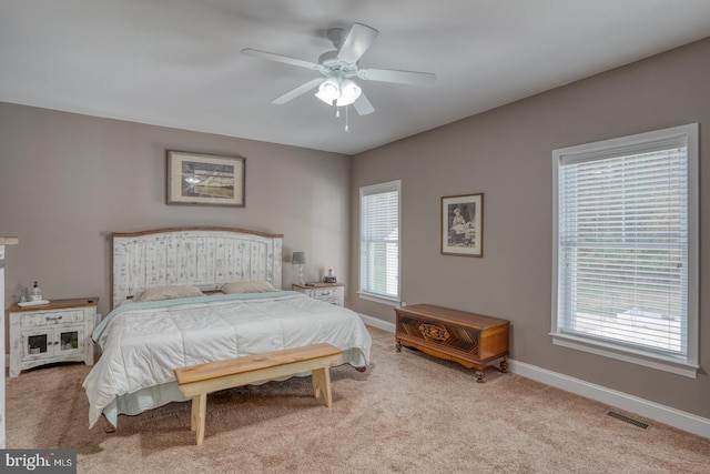 bedroom featuring light colored carpet and ceiling fan