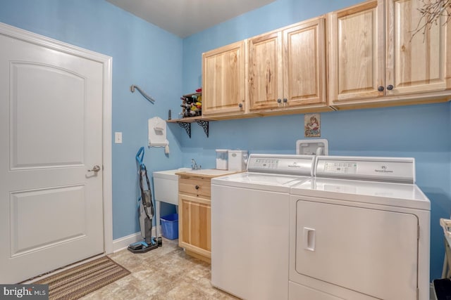 clothes washing area with cabinets and independent washer and dryer