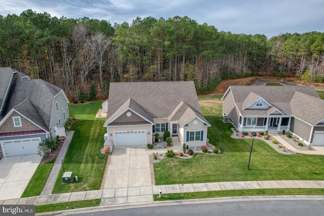 view of front of home with a porch, a garage, and a front lawn