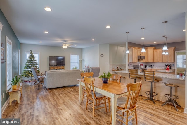 dining space featuring ceiling fan and light hardwood / wood-style floors