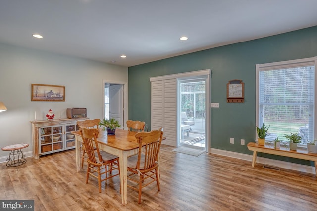 dining space with light hardwood / wood-style floors