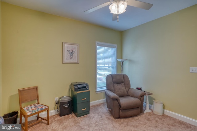 living area featuring ceiling fan and light carpet