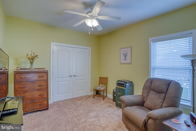 sitting room with light colored carpet and ceiling fan