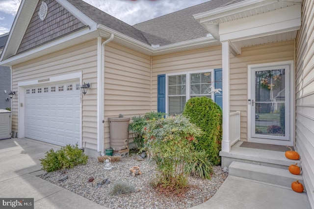 doorway to property with a garage