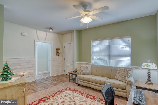 living room with ceiling fan and light hardwood / wood-style floors