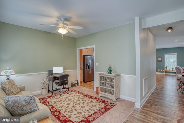 office with ceiling fan and light hardwood / wood-style floors