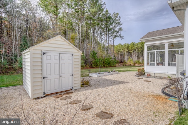 view of yard featuring a shed and a sunroom