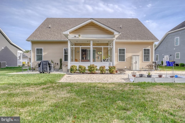 back of house with a lawn and central air condition unit