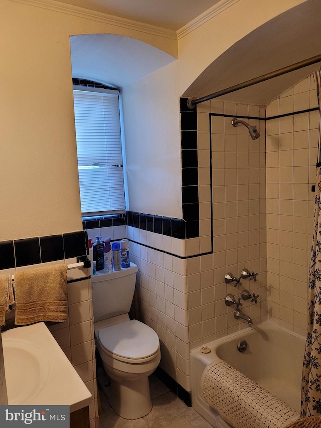 bathroom featuring tiled shower / bath combo, crown molding, tile walls, tile patterned flooring, and toilet