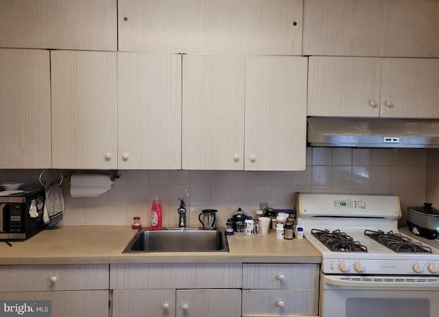 kitchen with white gas range oven, ventilation hood, tasteful backsplash, and sink