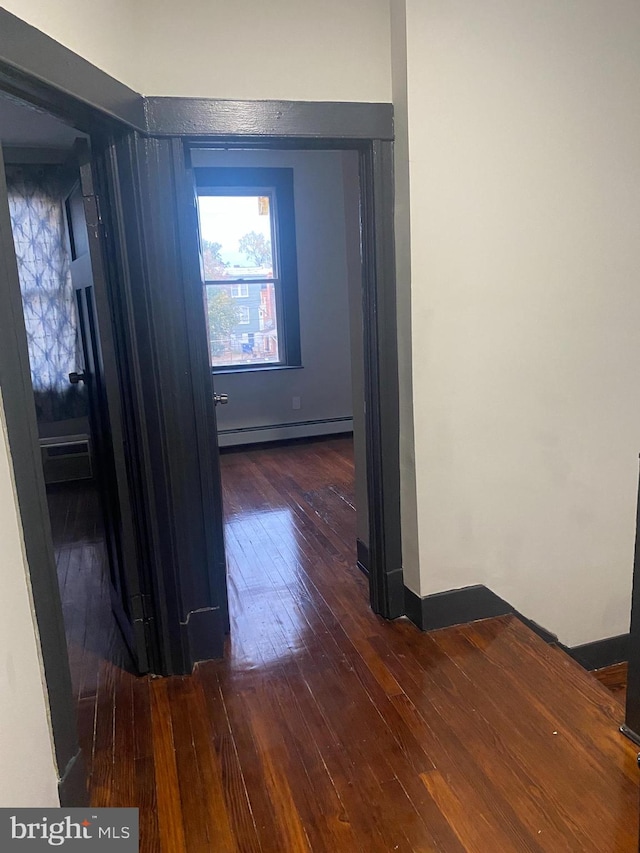 hall featuring dark hardwood / wood-style flooring and baseboard heating