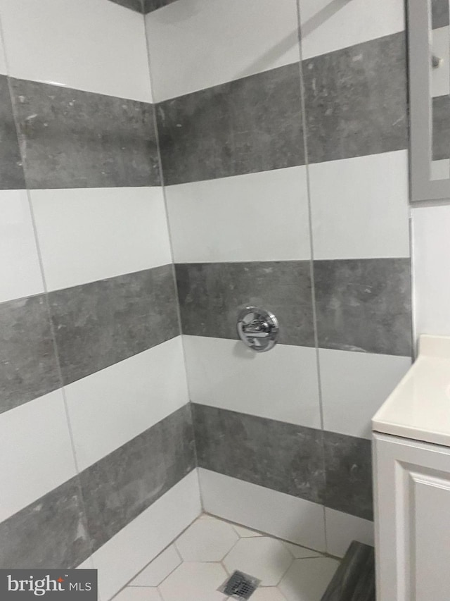 bathroom featuring a shower, tile patterned flooring, and vanity