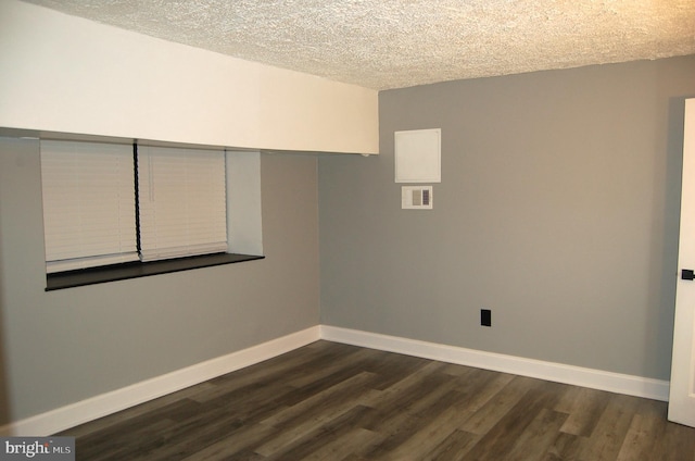 interior space featuring a textured ceiling and dark hardwood / wood-style floors