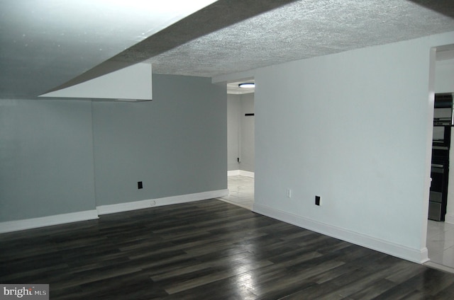 interior space with dark hardwood / wood-style floors and a textured ceiling