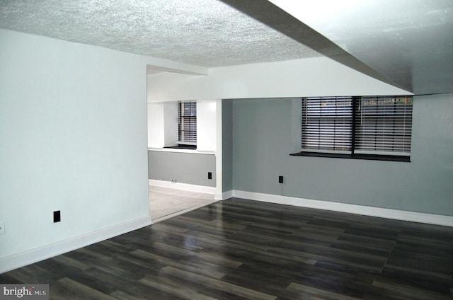 unfurnished room featuring a textured ceiling and hardwood / wood-style flooring