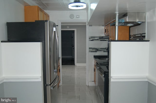 kitchen with stainless steel fridge, black stove, ventilation hood, light tile patterned floors, and white fridge