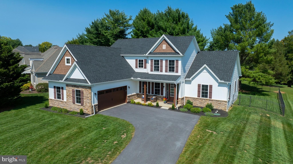 craftsman-style house with a front yard and a garage