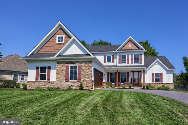 craftsman-style home featuring covered porch and a front yard