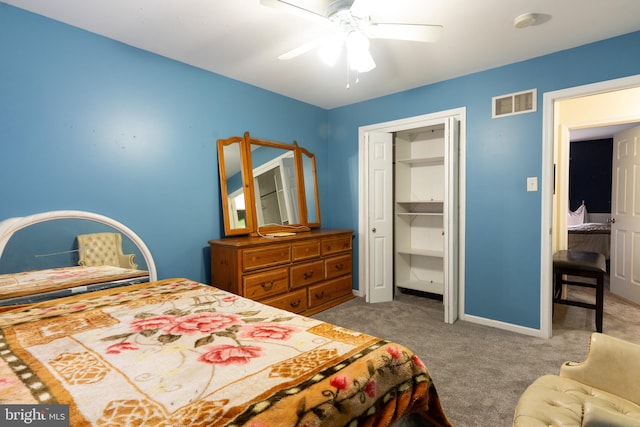 carpeted bedroom with ceiling fan and a closet