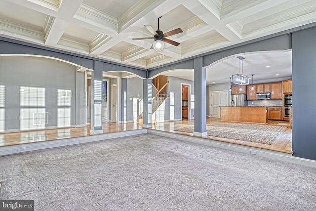 unfurnished living room with carpet, crown molding, beamed ceiling, and coffered ceiling