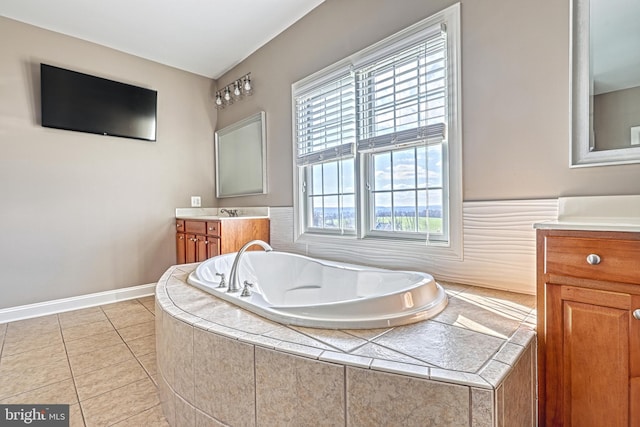 bathroom with vanity, tiled bath, and tile patterned floors