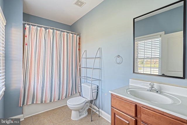 full bathroom featuring tile patterned floors, vanity, toilet, and shower / bathtub combination with curtain