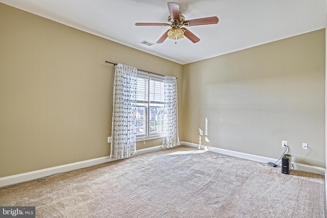 carpeted spare room featuring ceiling fan