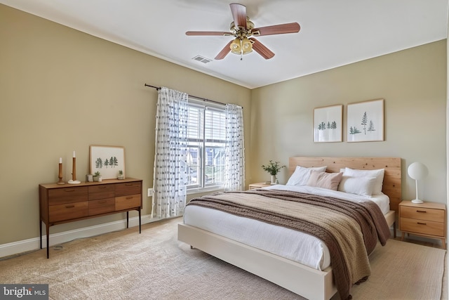 bedroom featuring ceiling fan and light carpet