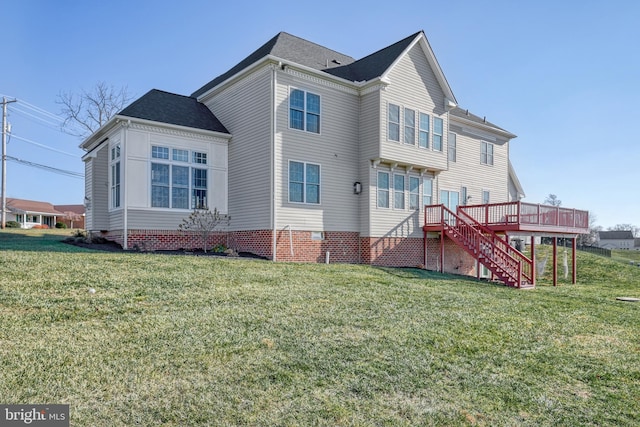 rear view of property with a deck and a lawn