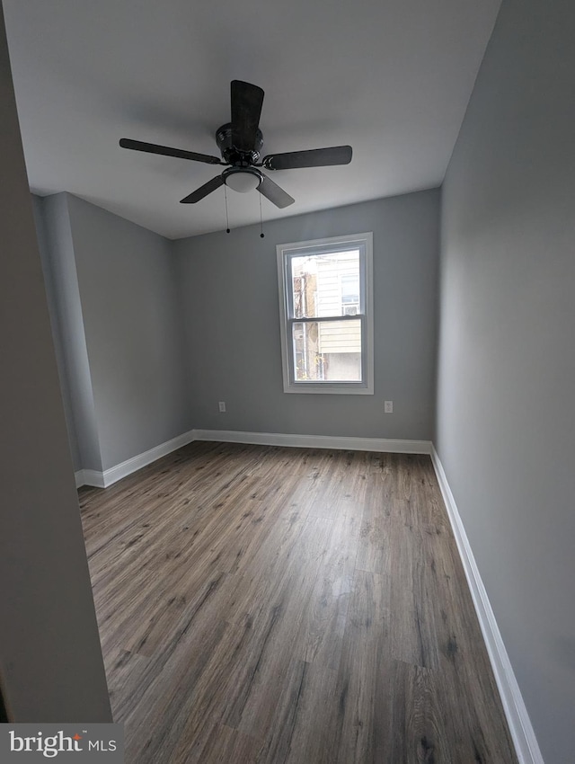 unfurnished room with ceiling fan and hardwood / wood-style flooring