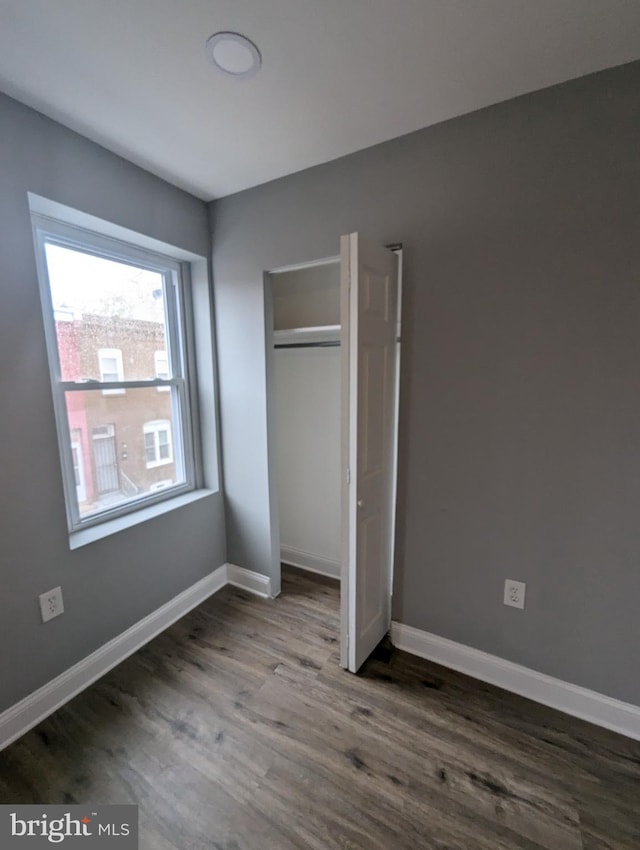 unfurnished bedroom featuring hardwood / wood-style flooring