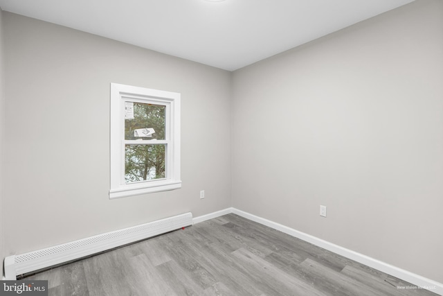 spare room with light hardwood / wood-style flooring and a baseboard radiator