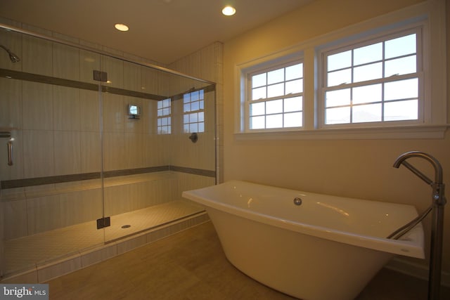 bathroom with tile patterned flooring and separate shower and tub