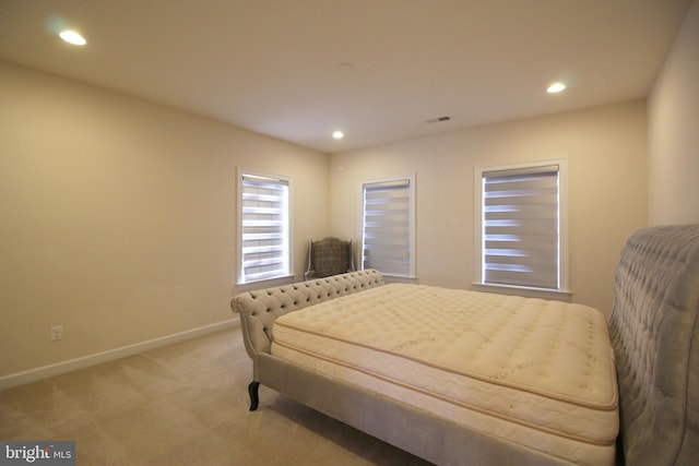 bedroom featuring light carpet