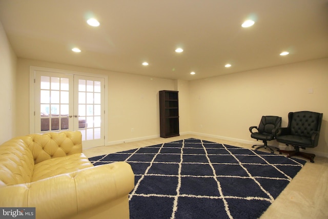 sitting room featuring french doors and carpet floors