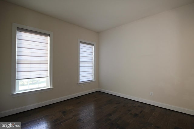 unfurnished room with dark hardwood / wood-style floors