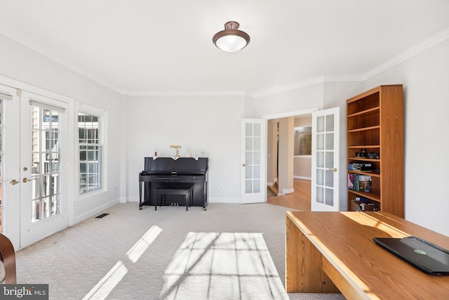 carpeted office with crown molding and french doors