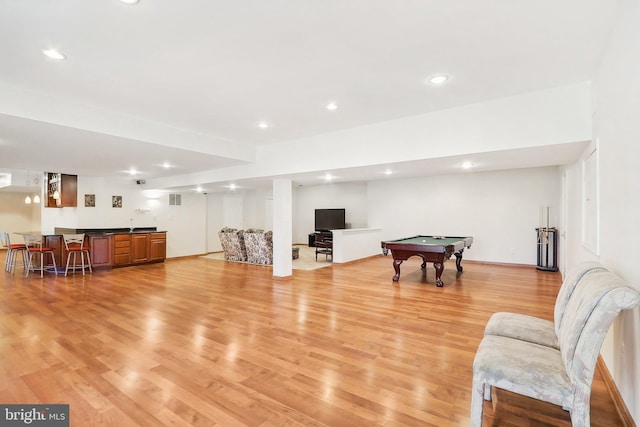 game room with bar area, light hardwood / wood-style flooring, and pool table