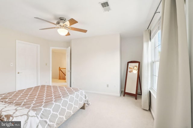 bedroom featuring ceiling fan and light carpet