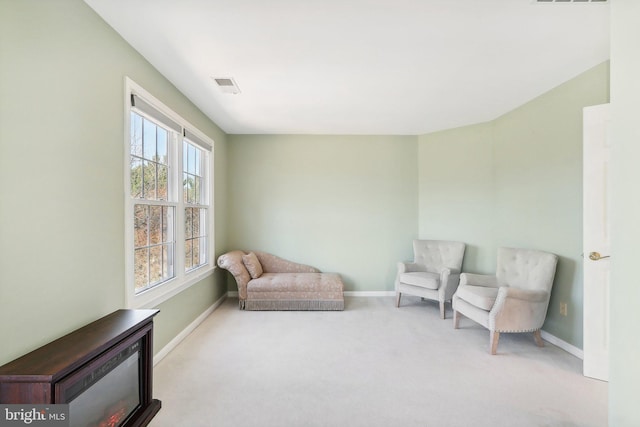 living area with light carpet