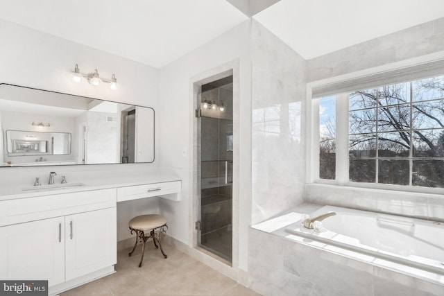 bathroom with tile patterned floors, vanity, and shower with separate bathtub